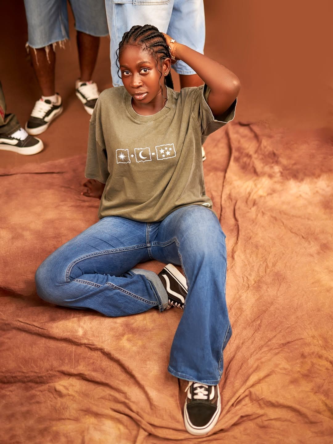 KAIROVA olive celestial tee — seated look